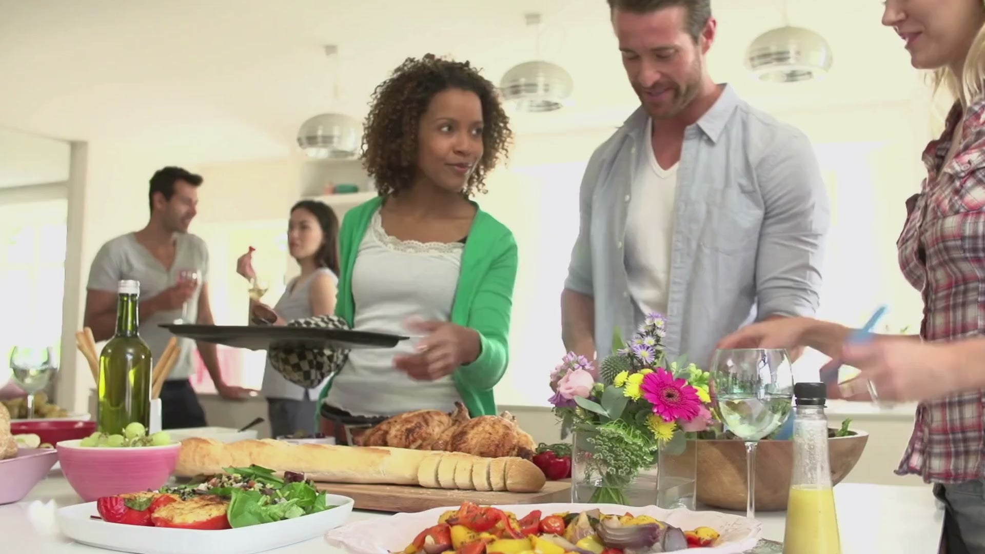 Load video: Group of friends gathering in kitchen